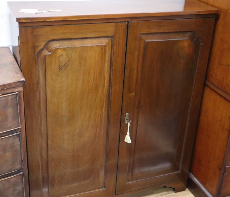 A George III mahogany cupboard enclosed by panelled doors, W.94cm, D.29cm, H.111cm